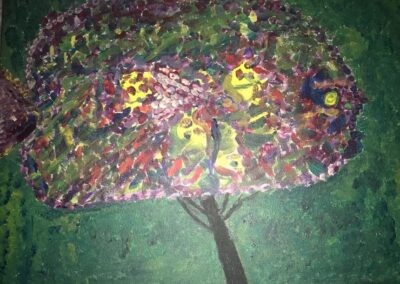Impressionistic fish shape made of yellow, brown, red, pink, green, blue, maroon, and brown on top of a tree trunk with green in background.