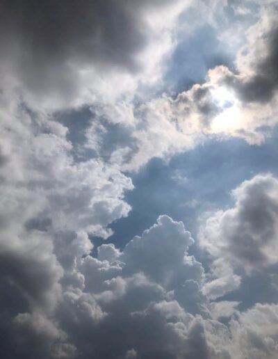 Grey and white fluffy clouds blow across the sky.